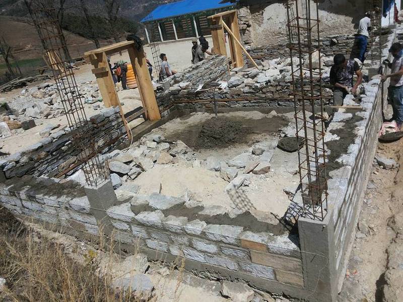 Trekkers collectively helping to build the foundations for new classrooms in Lura village