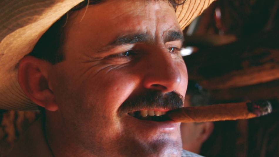 A local farmer samples his tobacco | Eve Ollington