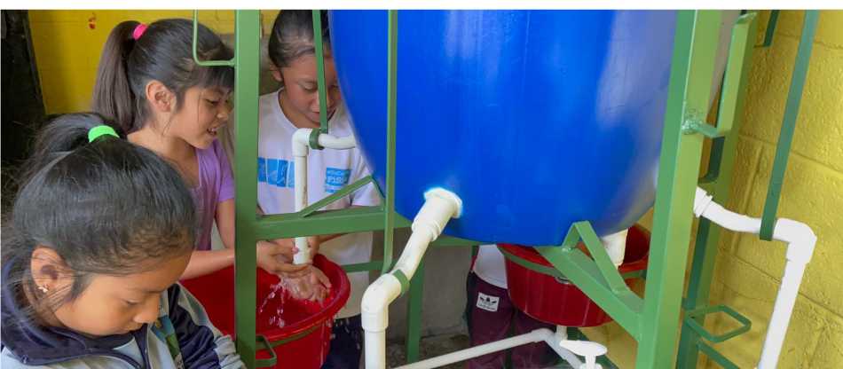Local school children using WASH sanitation hand washing system in Guatemalan water project | Los Buenos Vencinos NGO Guatemala