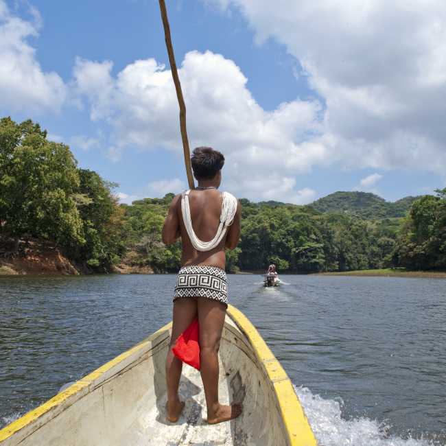 Traditional Embera Indian on a long boat in Panama