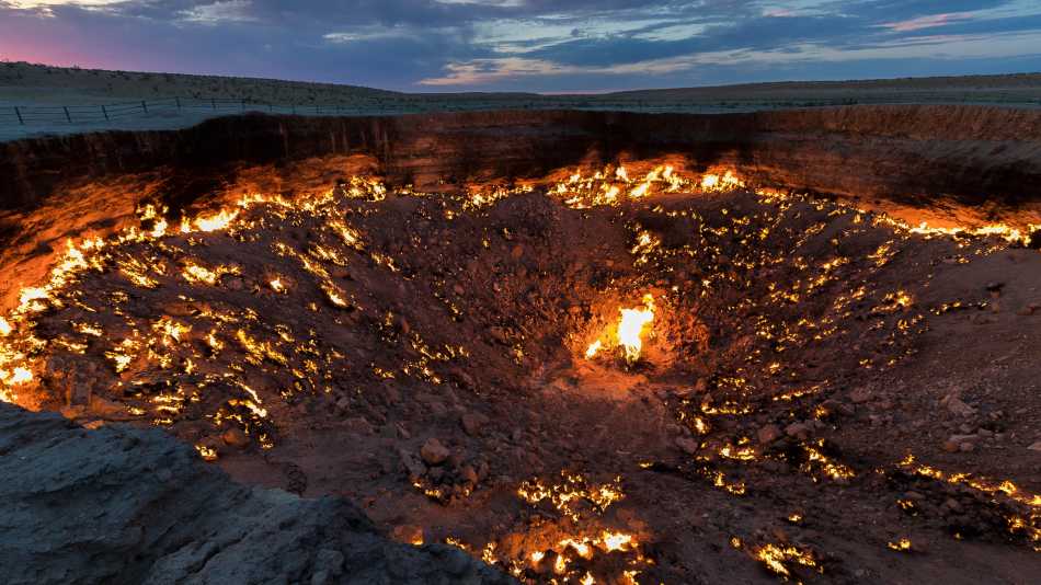 Turkmenistan's Darvaza Gas Crater, also known as the 'Door to Hell', at sunset | Richard I'Anson