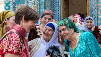 Pilgrims with traveller at Shah-i-Zinda, avenue of mausoleums, Samarkand