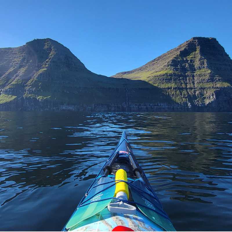 Sea kayaking beneath the mountains of the Faroe Islands