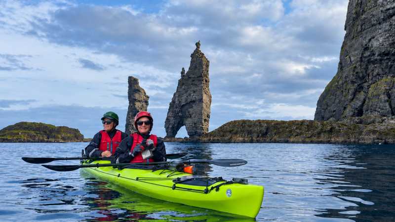 Sea kayaking beneath the iconic Risin og Kellingin (the Giant and the Witch) sea stacks - Faroe Islands: Kayaking the North Atlantic, Faroe Islands