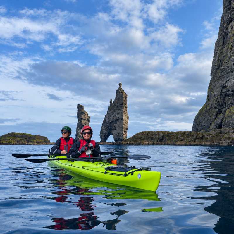 Sea kayaking beneath the iconic Risin og Kellingin (the Giant and the Witch) sea stacks | Dan Stavert
