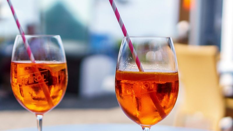 Italy food tour, two Aperol Spritz cocktails on an outdoor café table - Alps to Aperitivo: Northern Italy with Ben Groundwater, Italy