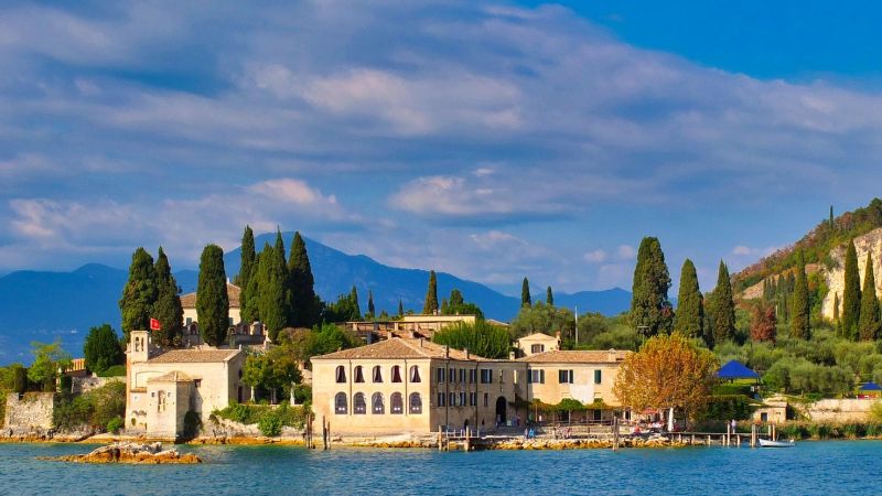 Lake Garda peninsula with lakeside villas and cypress trees beneath green hills - Alps to Aperitivo: Northern Italy with Ben Groundwater, Italy