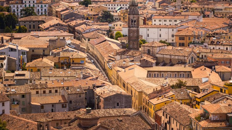 Verona's terracotta rooftops spread beneath a tall bell tower in the historic center - Alps to Aperitivo: Northern Italy with Ben Groundwater, Italy
