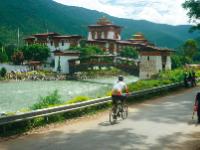 Cycling past the Punakha Dzong Monastery in Bhutan -  Photo: Grasshopper Adventures