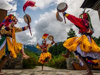 Bhutan masked dancers perform a traditional cham dance in a mountain courtyard |  Lachlan Gardiner