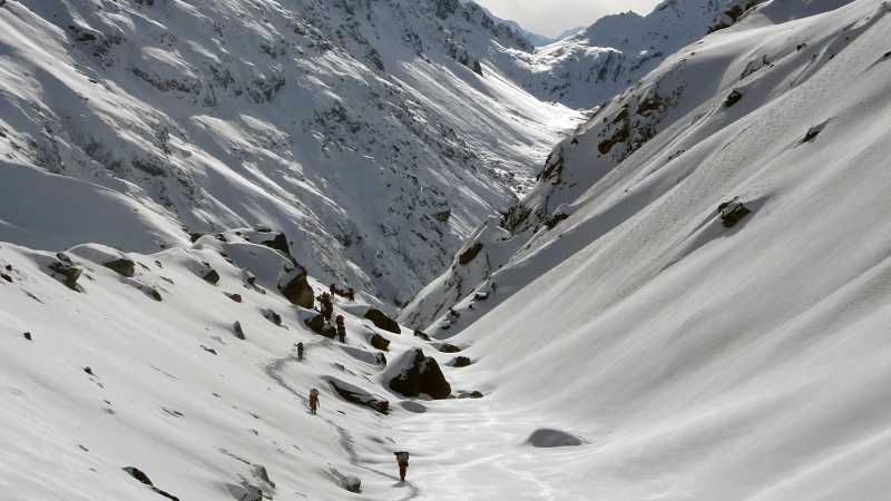 Trekking through a snowy valley during Stage 2 of the Great Himalaya Trail | Jasmine Star