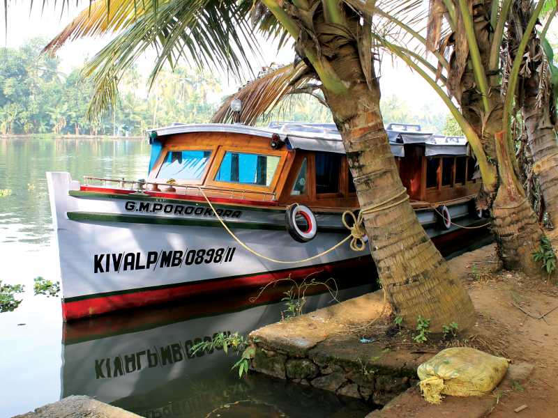 Trekkers Kerala houseboat anchored on the waterfront | Jaclyn Loft