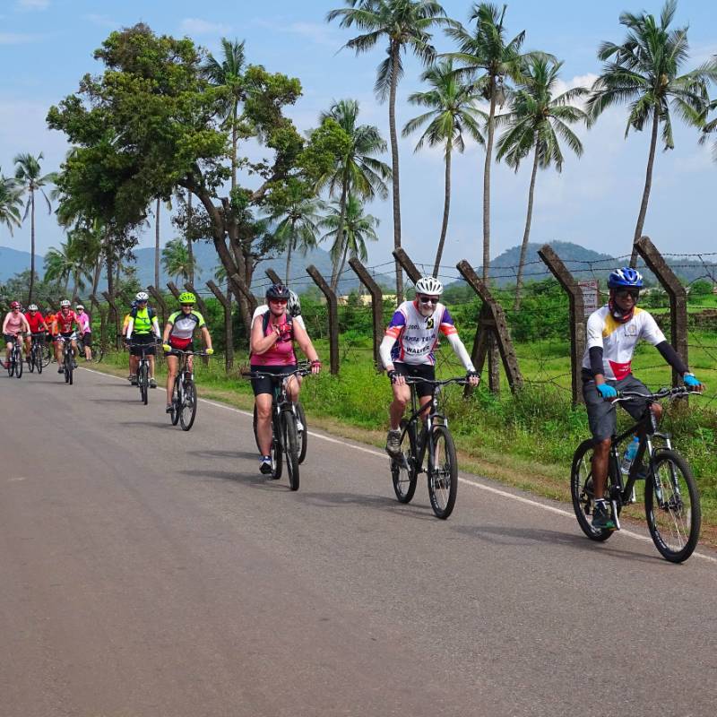 Happy cyclists on a quiet road in Karnataka, India