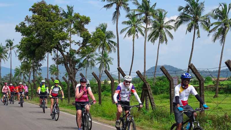 Happy cyclists on a quiet road in Karnataka, India