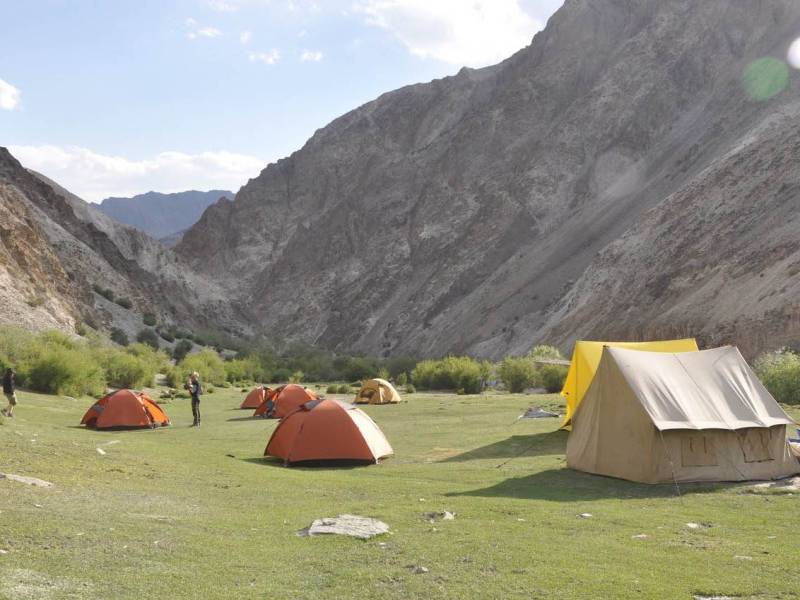 Comfortable and well-equipped tents set amidst the serene landscapes of the Indian Himalayas.