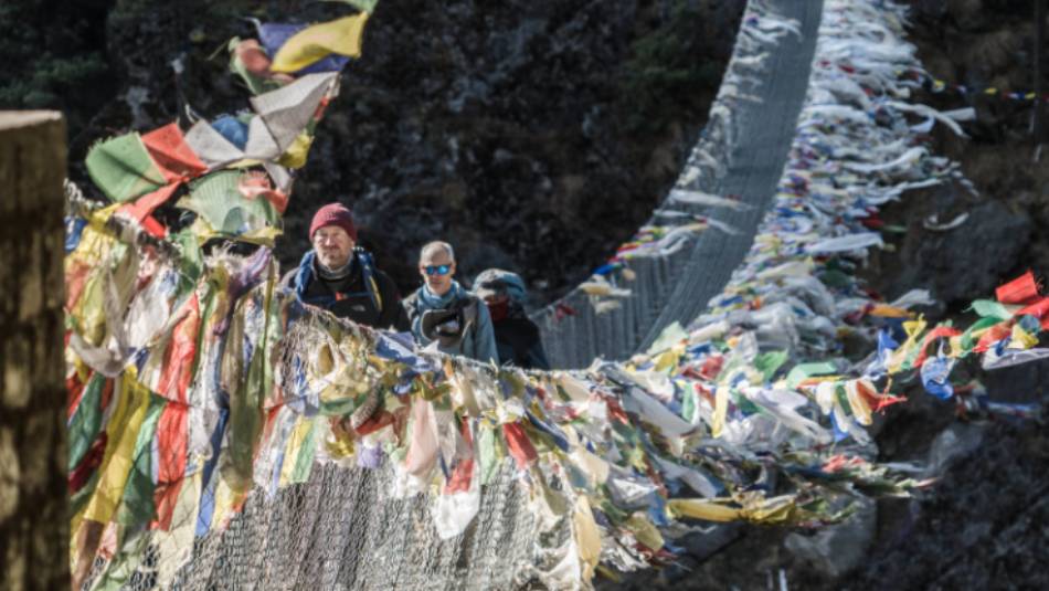 Cross deep ravines on suspension bridges fluttering with prayer flags | Dan Cassar