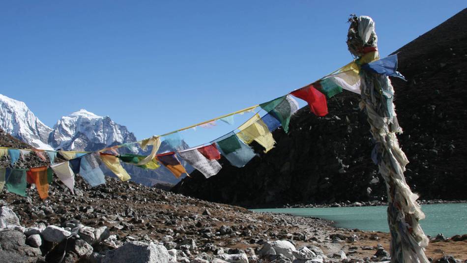 Prayer flags over Gokyo lake in Nepal's Sagarmatha National Park | Keri May