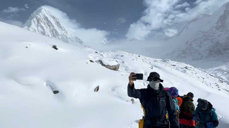 Pumori poking behind trekkers on the Everest Three Passes Trek, Nepal | Brad Atwal