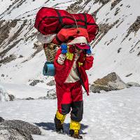 Local porter carrying gear along high passes in Nepal |  <i>Lachlan Gardiner</i>
