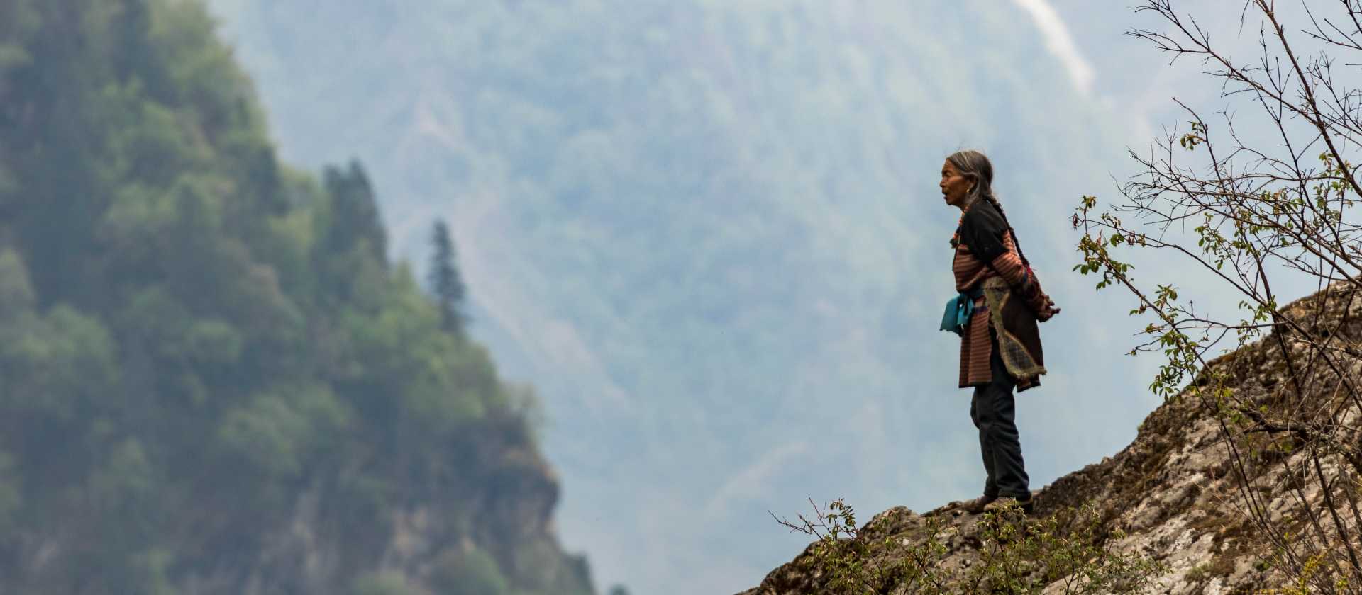 A local woman takes in the view of her part of the Himalaya | Lachlan Gardiner