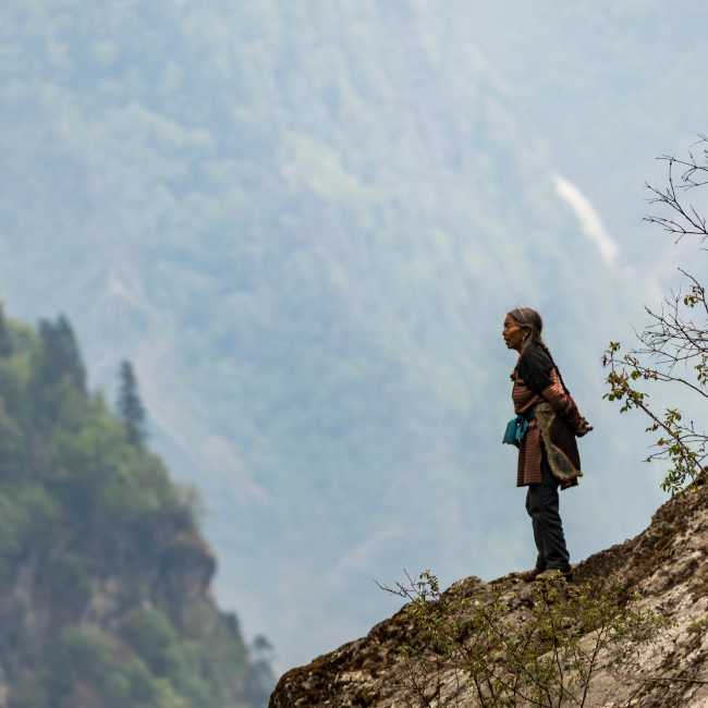 A local woman takes in the view of her part of the Himalaya | Lachlan Gardiner