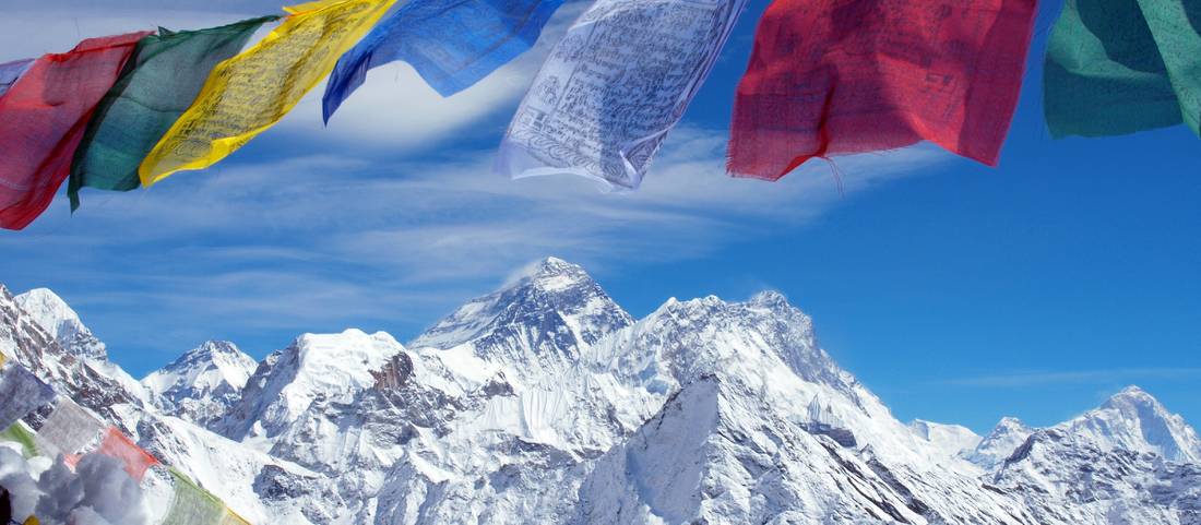 Mt Everest framed by prayer flags from the summit of Gokyo Ri |  <i>Greg Bradley</i>