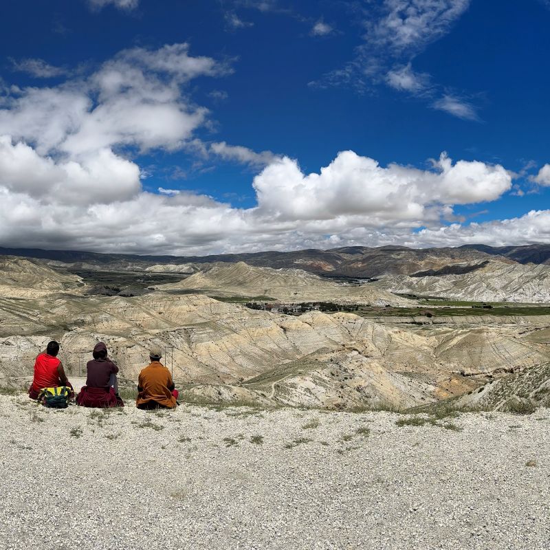 Upper Mustang trekking pass above Lo Manthang, monks resting overlooking an arid valley