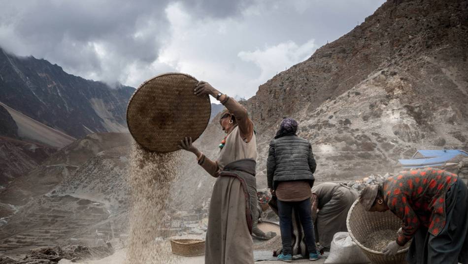 Locals go about their business in the village of Nar | Stephen White