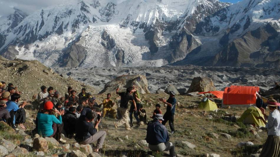 Porters dancing at camp beside the Hispar glacier, Karakoram, Pakistan | Tim Macartney-Snape