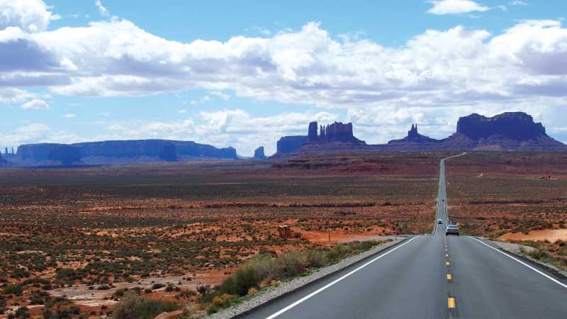 A long open road through Monument Valley - Rocky Mountain, Yellowstone and Grand Canyon Trails, United States