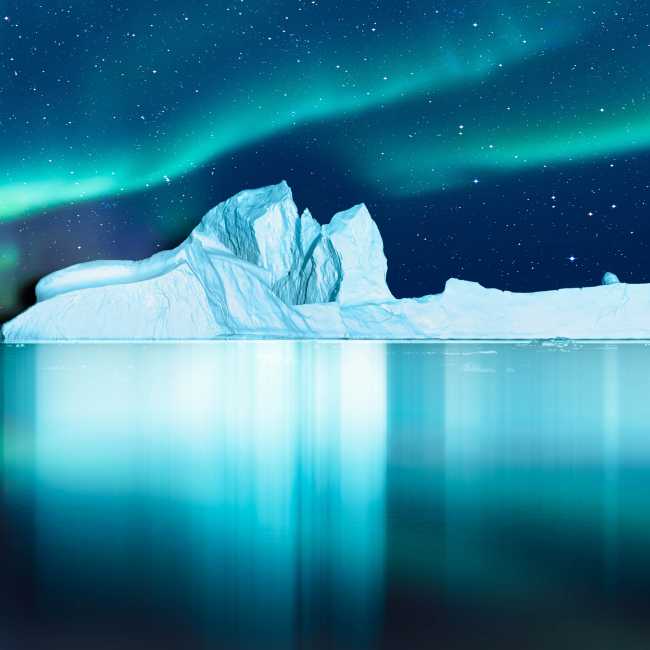 Aurora Borealis lights up the fjord in Greenland