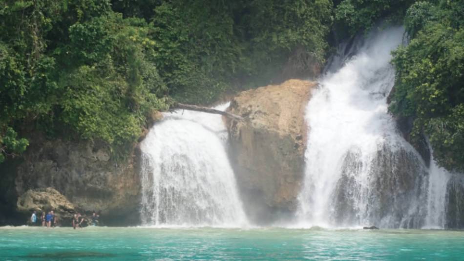 Kiti Kiti Waterfalls cascade into the ocean off the coast of West Papua