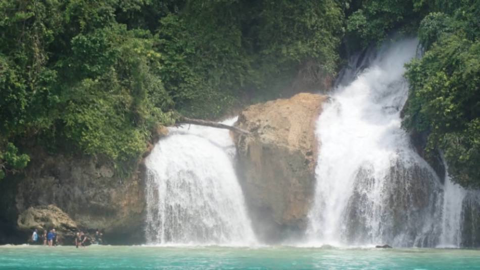 Kiti Kiti Waterfalls cascade into the ocean off the coast of West Papua