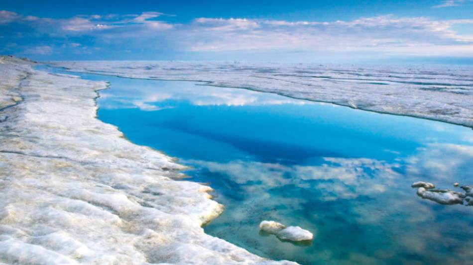 The blue sky is reflected in the Arctic Ocean