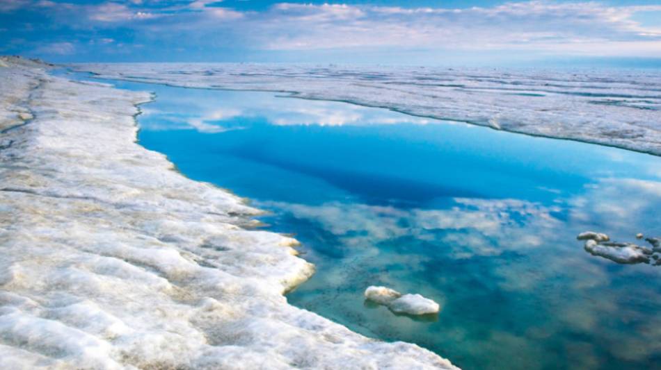 The blue sky is reflected in the Arctic Ocean