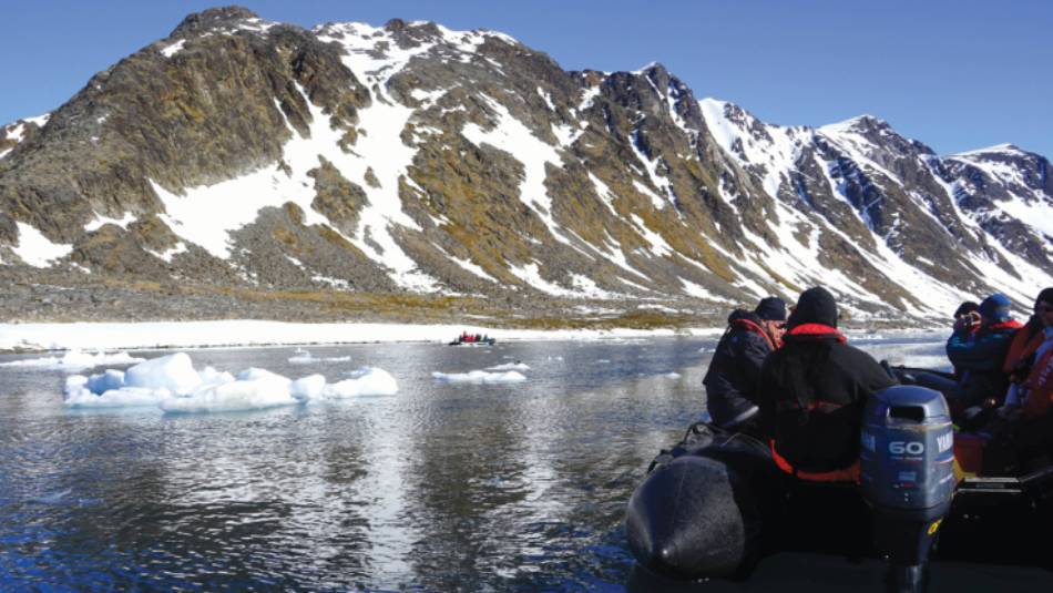Zodiac cruising the calm Arctic Ocean | Gesine Cheung