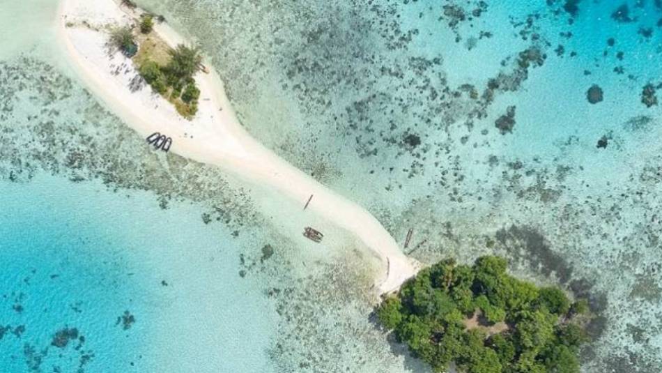 Aerial shot of an uninhabited island in the western pacific | E Bell