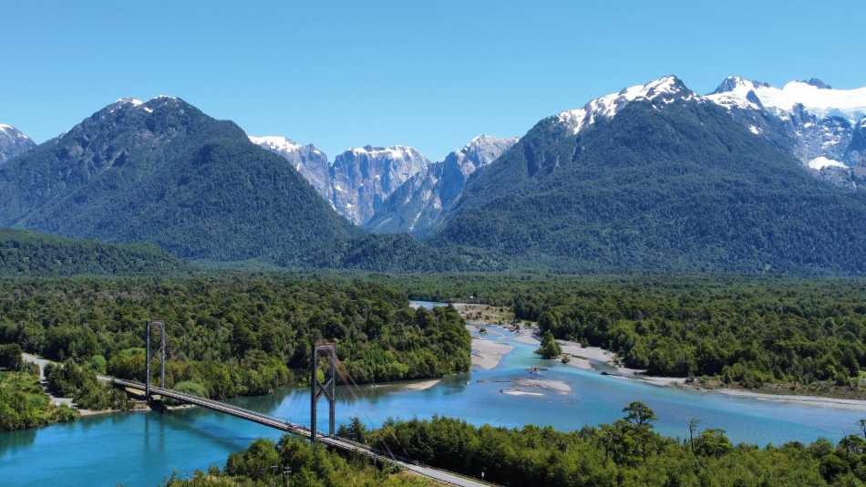 Take in the spectacular Patagonia landscape while cycling across the Yelcho suspension bridge