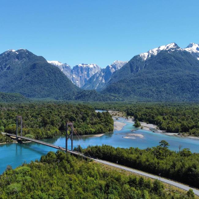 Take in the spectacular Patagonia landscape while cycling across the Yelcho suspension bridge