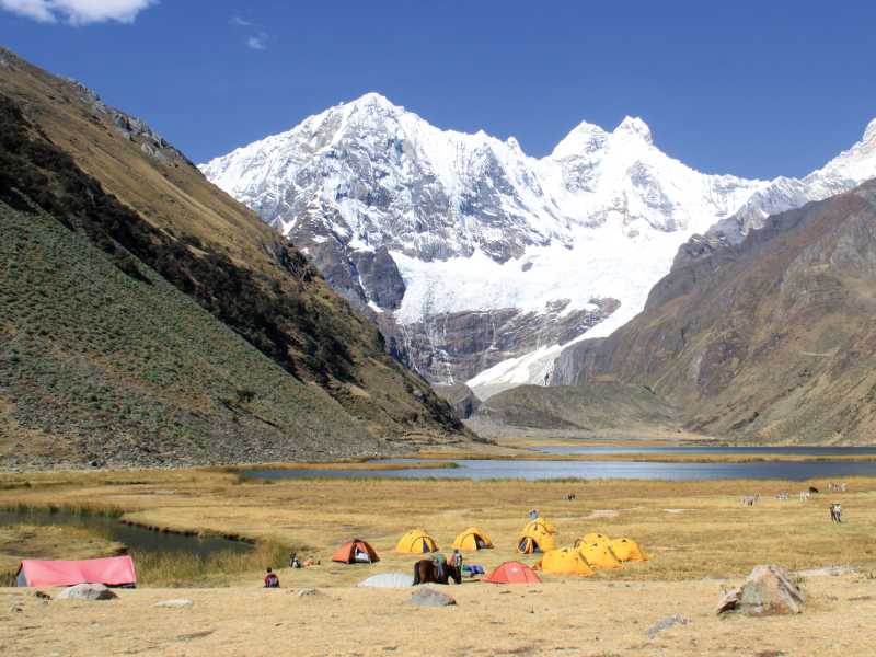 Camping amongst the rugged snowcapped peaks of Huayhuash, Peru | Ken Harris