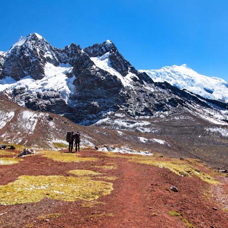 Ausangate Trek trekkers pause before snow-capped peaks in the Peruvian Andes