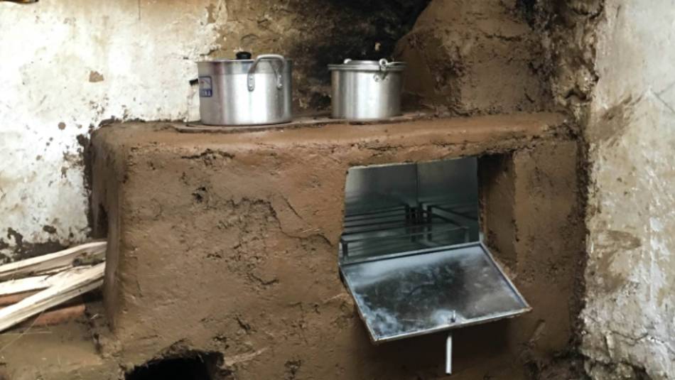 Part way through installing a new cook stove in a kitchen in Huilloc village, Peru | Dnona Lawrence