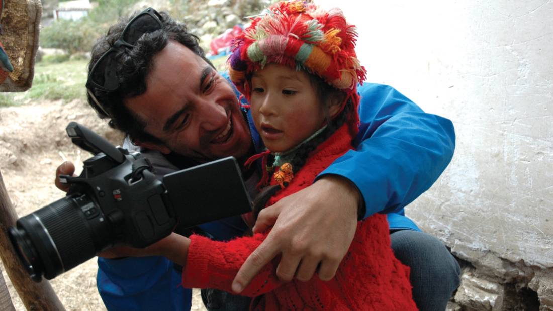 Hiker interacting with Quechua child |  <i>Donna Lawrence</i>