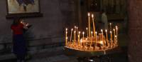 Candles lit inside Gergeti Trinity Church | Julie Haber