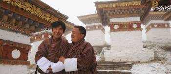 Two local Bhutanese men standing outside a temple | Liz Light